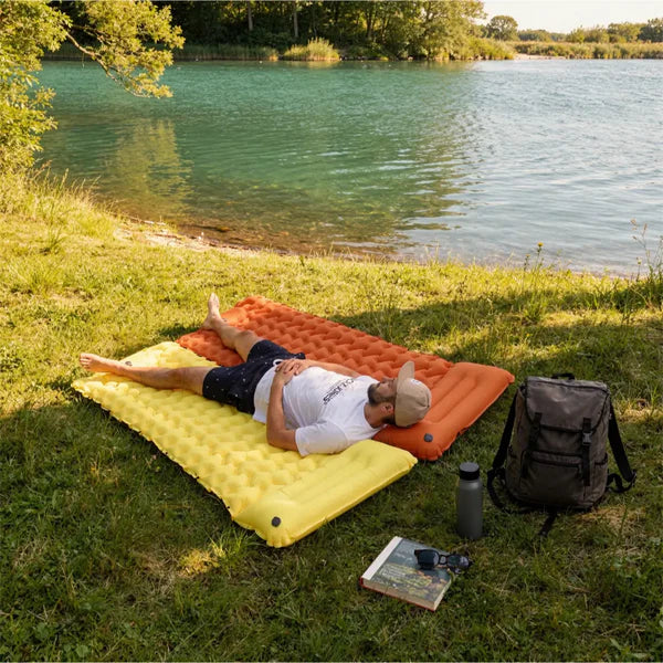 Person relaxing on the Lounge Mat at the beach